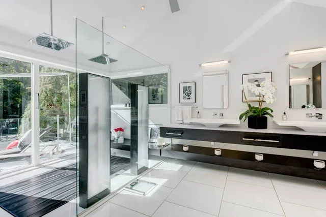 a spacious bedroom with a bed and a chandelier