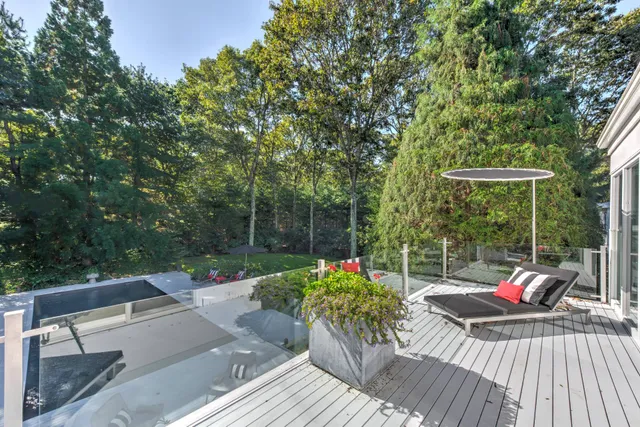 a view of a table and chairs in patio with potted plants