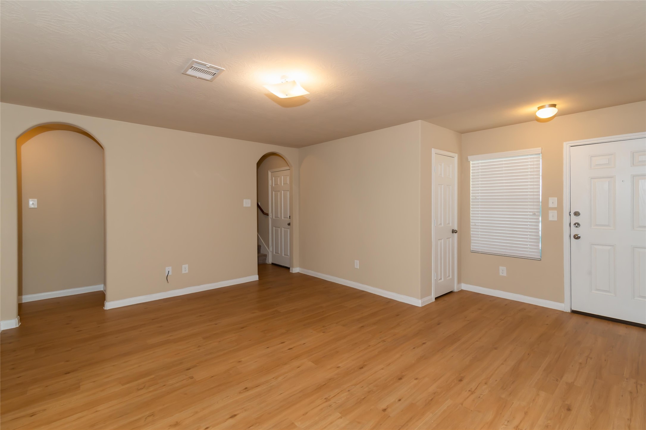2410 Gibbs Bend Court Houston, TX 77073 - Photo 5 of 12 an empty room with wooden floor and windows