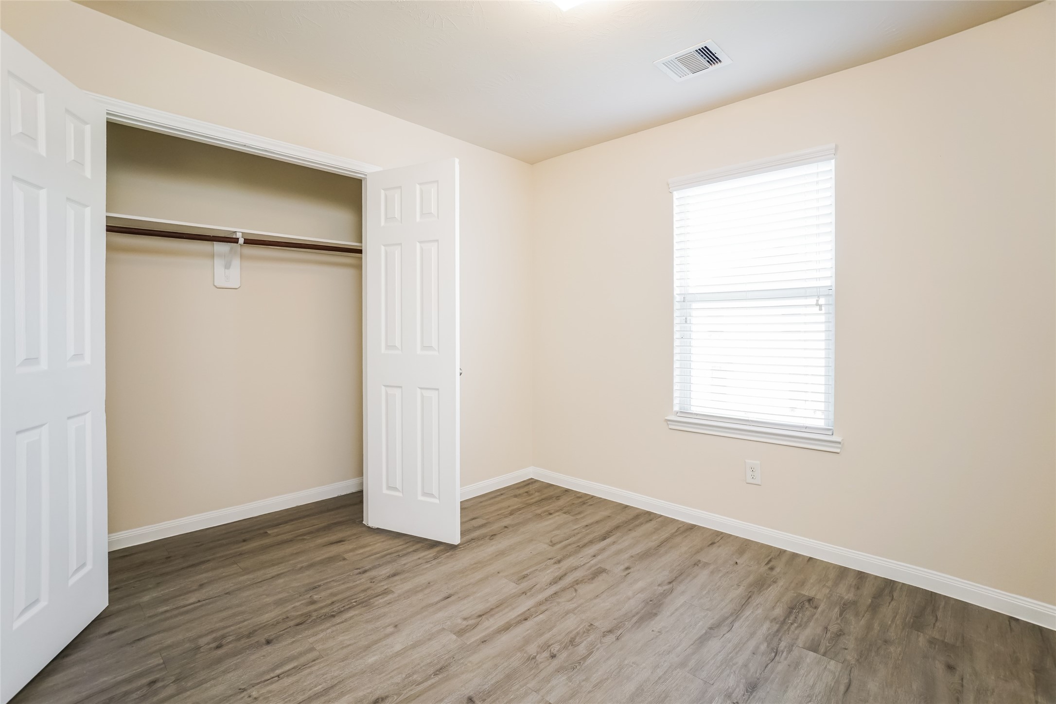 2410 Gibbs Bend Court Houston, TX 77073 - Photo 10 of 12 an empty room with wooden floor and a window