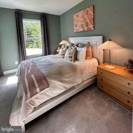 a bedroom with a bed and dresser