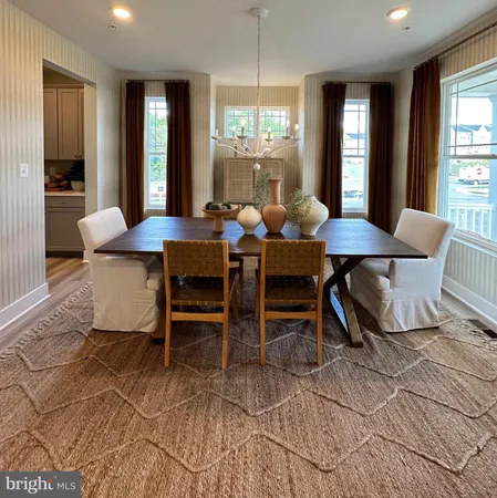a view of a kitchen with kitchen island and stainless steel appliances