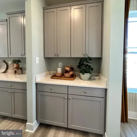 a kitchen with counter top space a sink a stove and a wooden floors