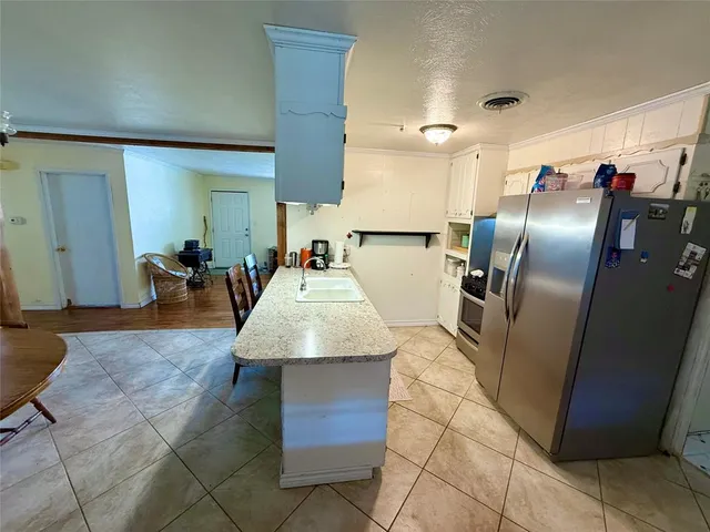 a kitchen with stainless steel appliances granite countertop a refrigerator and a stove