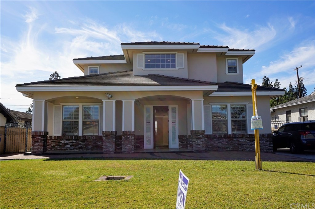 a view of a house with swimming pool and a porch