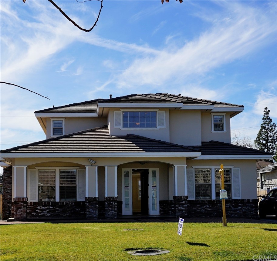705 Cortez Road Arcadia, CA 91007 - Photo 3 of 70 a view of a white house with a big yard and potted plants