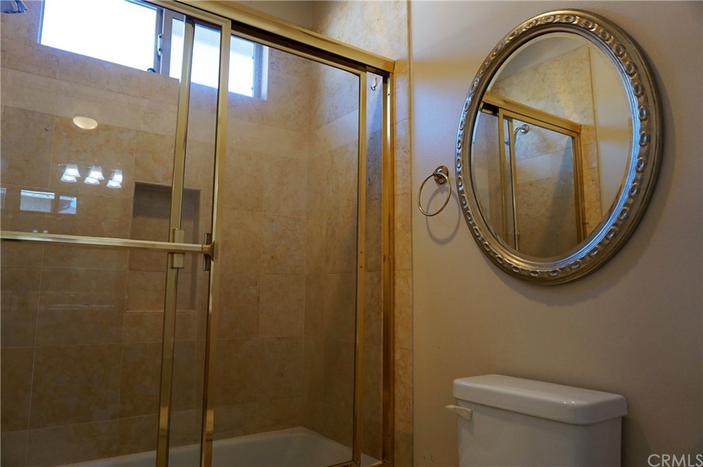 705 Cortez Road Arcadia, CA 91007 - Photo 31 of 70 a bathroom with a mirror a toilet and a shower