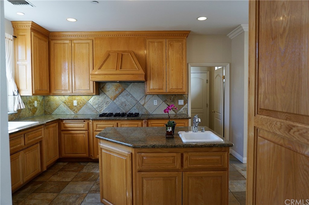705 Cortez Road Arcadia, CA 91007 - Photo 40 of 70 a kitchen with stainless steel appliances granite countertop a sink and a refrigerator