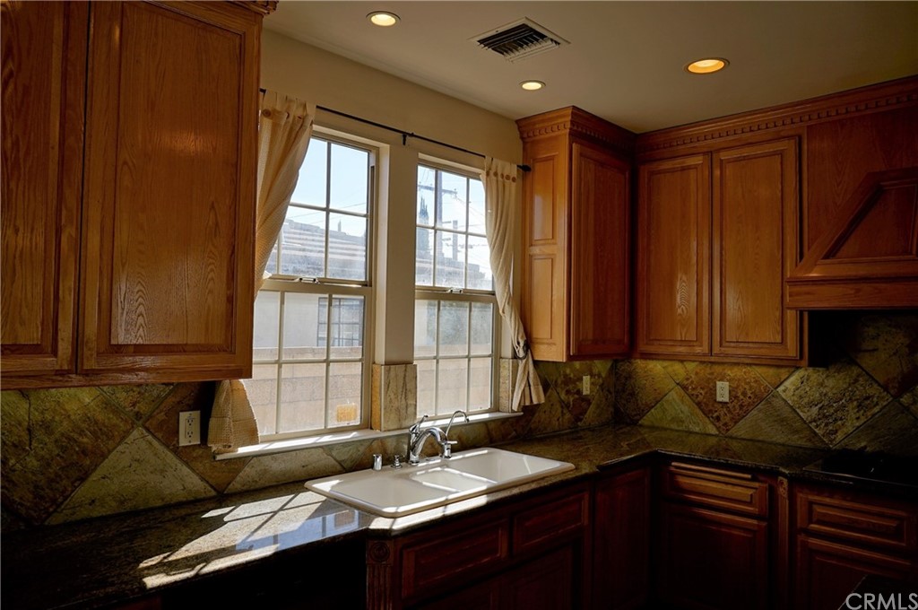 705 Cortez Road Arcadia, CA 91007 - Photo 41 of 70 a kitchen with a sink stove and cabinets