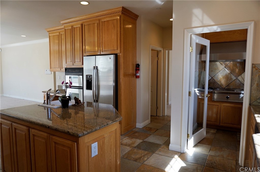 705 Cortez Road Arcadia, CA 91007 - Photo 43 of 70 a kitchen with kitchen island granite countertop a refrigerator and a sink