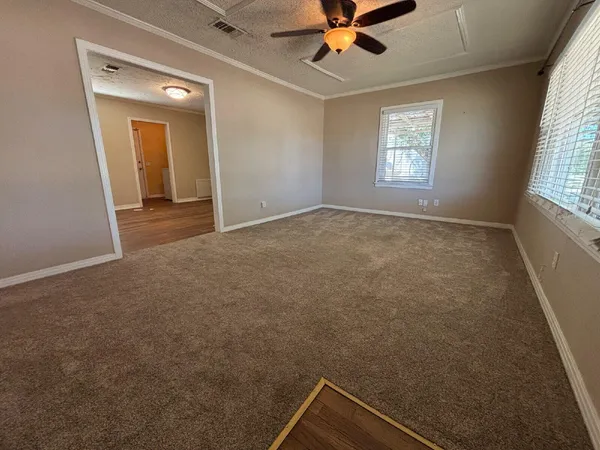 a view of an empty room and a window