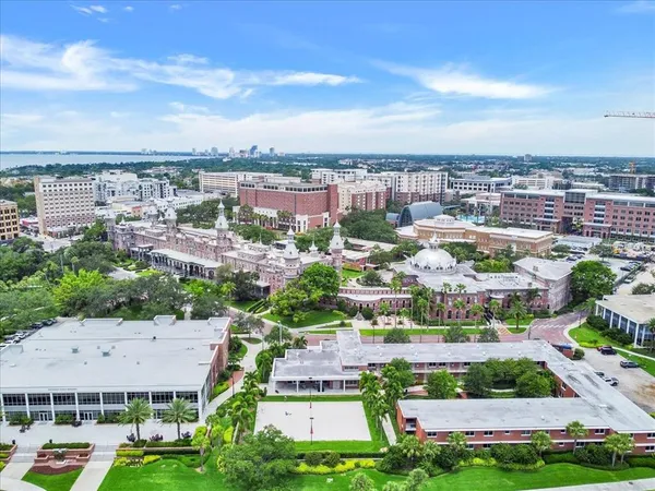 a view of a swimming pool with outdoor seating and a yard