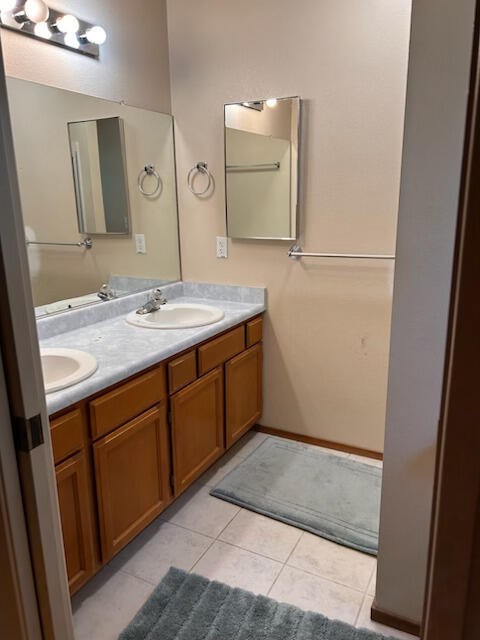 2046 Silverfield Loop Redding, CA 96002 - Photo 6 of 17 a bathroom with a granite countertop sink and a mirror