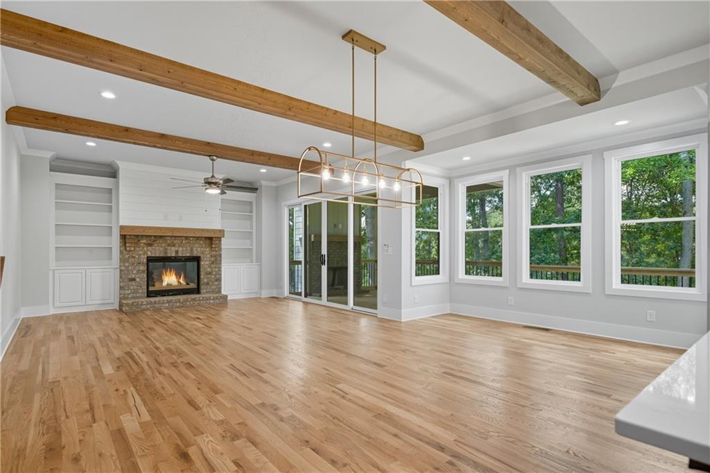 116 Dallas Mark Drive Canton, GA 30115 - Photo 13 of 43 a view of an empty room with wooden floor fireplace and a window