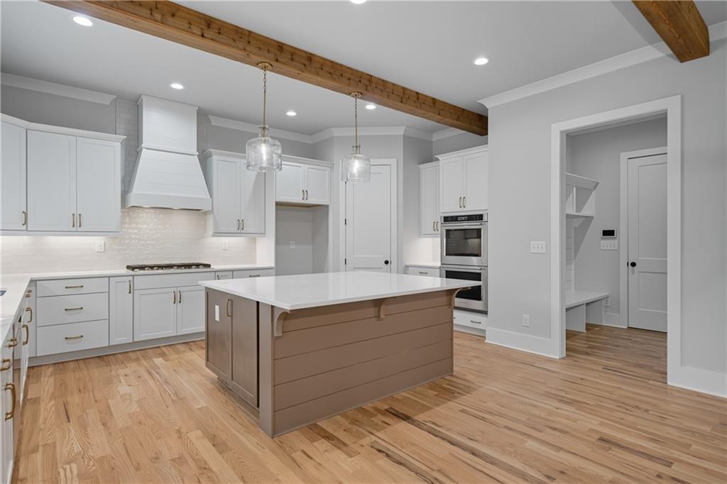 116 Dallas Mark Drive Canton, GA 30115 - Photo 16 of 43 a kitchen with white cabinets and stainless steel appliances