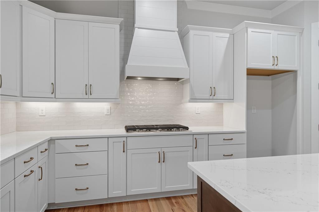 116 Dallas Mark Drive Canton, GA 30115 - Photo 17 of 43 a kitchen with white cabinets and white appliances