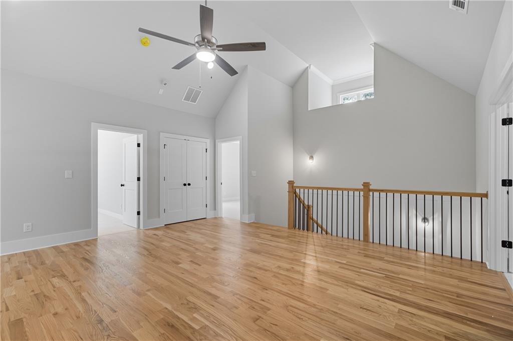116 Dallas Mark Drive Canton, GA 30115 - Photo 27 of 43 a view of an empty room with wooden floor and a ceiling fan