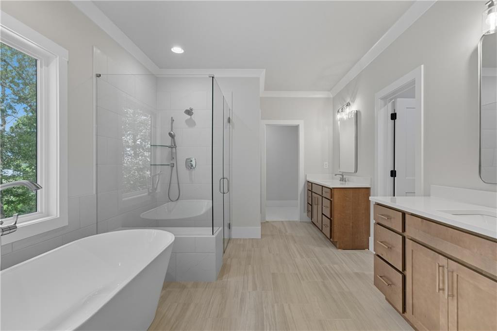 116 Dallas Mark Drive Canton, GA 30115 - Photo 31 of 43 a spacious bathroom with a tub shower a sink and a mirror