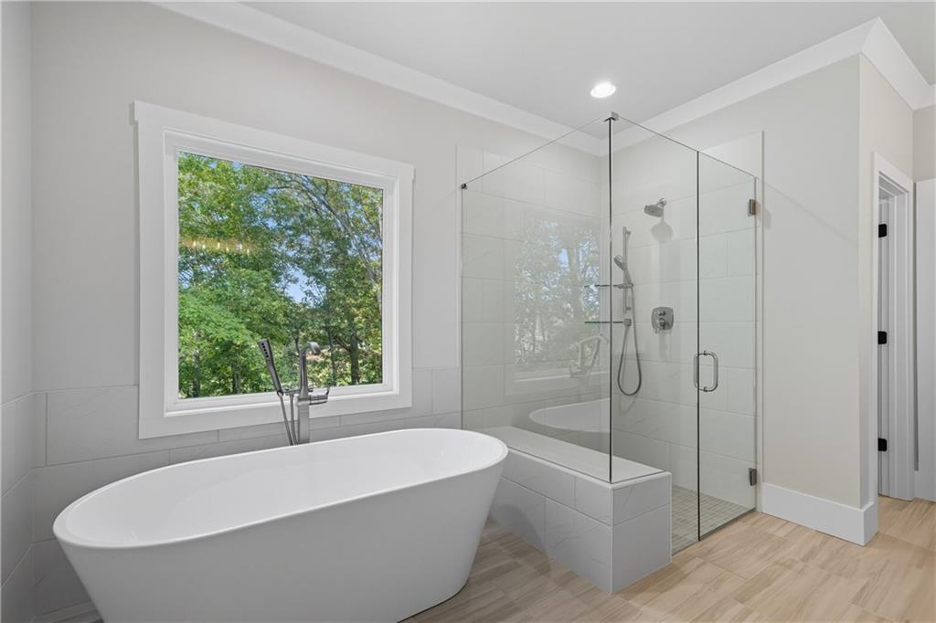 116 Dallas Mark Drive Canton, GA 30115 - Photo 33 of 43 a white bath tub sitting next to a shower