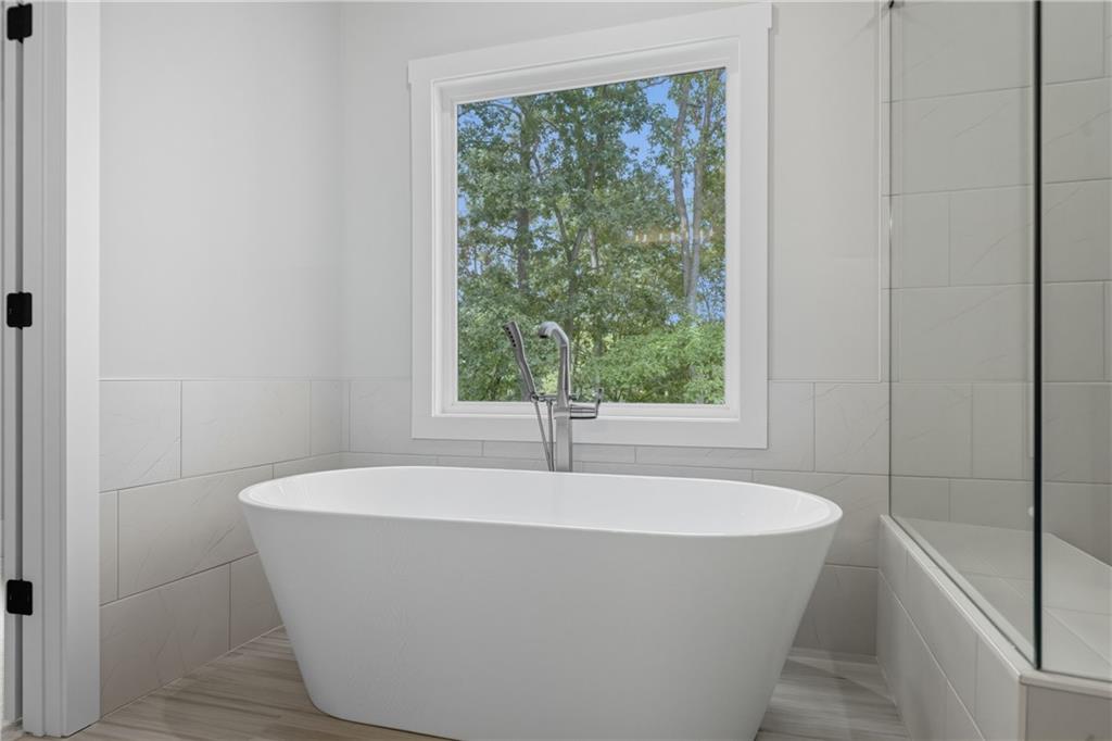 116 Dallas Mark Drive Canton, GA 30115 - Photo 35 of 43 a white bath tub sitting in a bathroom next to a window