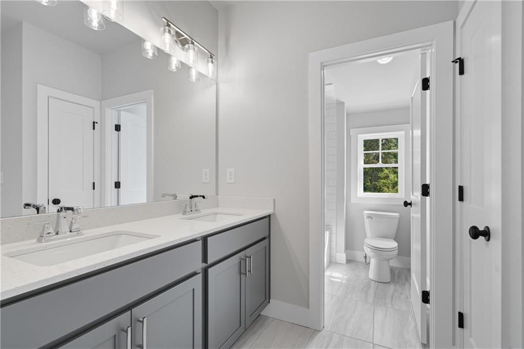 116 Dallas Mark Drive Canton, GA 30115 - Photo 40 of 43 a bathroom with a granite countertop sink a toilet and a large mirror