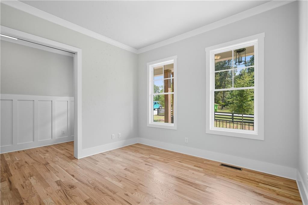 116 Dallas Mark Drive Canton, GA 30115 - Photo 4 of 43 a view of an empty room with wooden floor and a window
