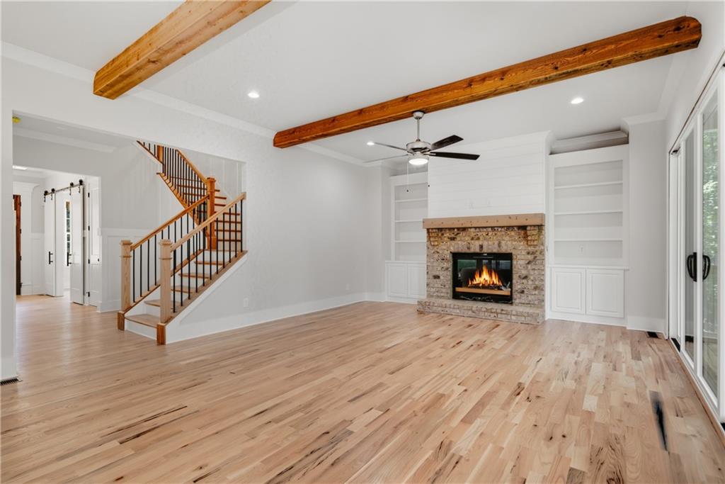 116 Dallas Mark Drive Canton, GA 30115 - Photo 7 of 43 a view of an empty room with wooden floor fireplace and a window