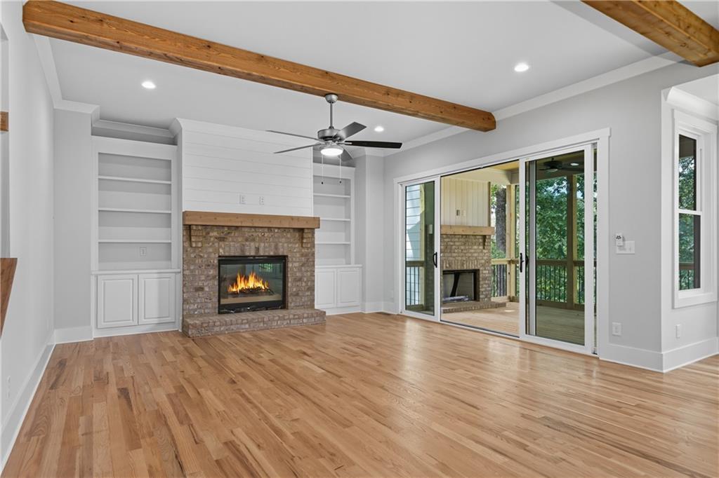 116 Dallas Mark Drive Canton, GA 30115 - Photo 8 of 43 a view of an empty room with wooden floor fireplace and a window