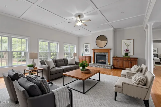 a living room with furniture a fireplace and a large window