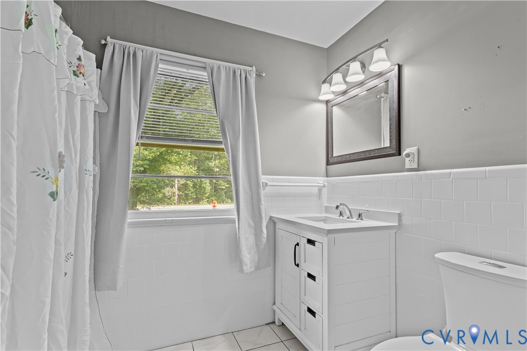7586 Willson Road Henrico, VA 23231 - Photo 16 of 32 Bathroom with tile patterned flooring, vanity, til