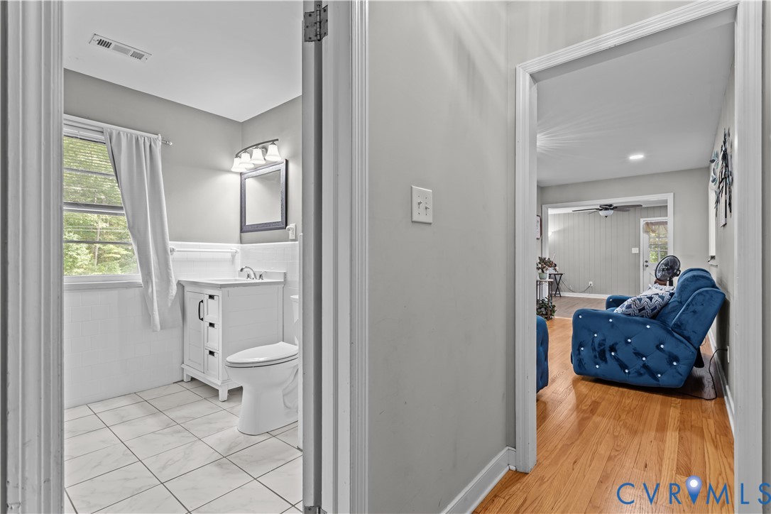 7586 Willson Road Henrico, VA 23231 - Photo 18 of 32 Bathroom with vanity, a wainscoted wall, a ceiling