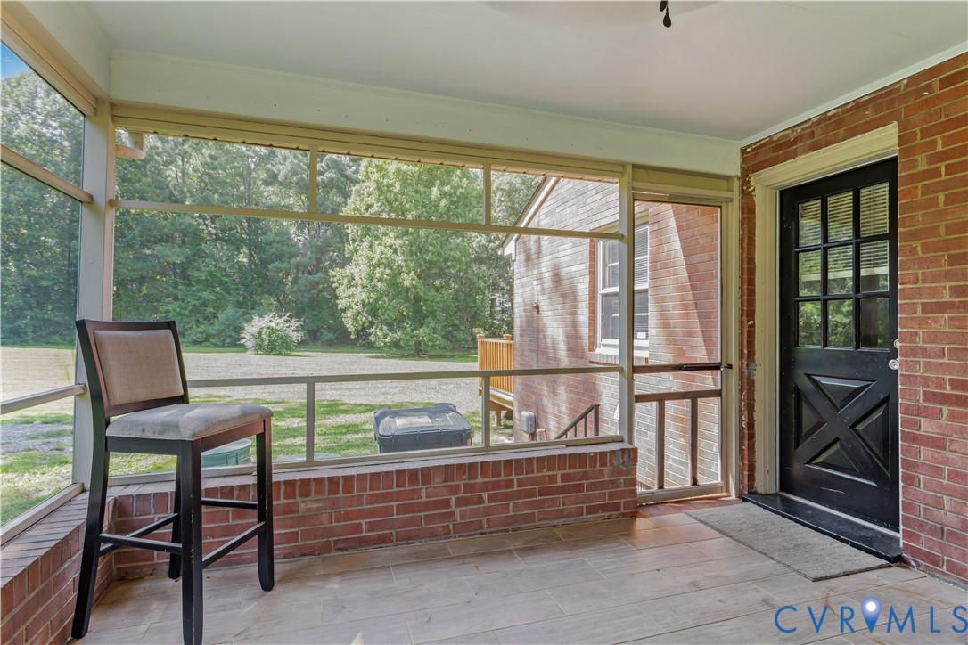 7586 Willson Road Henrico, VA 23231 - Photo 28 of 32 Unfurnished sunroom featuring view of wooded area