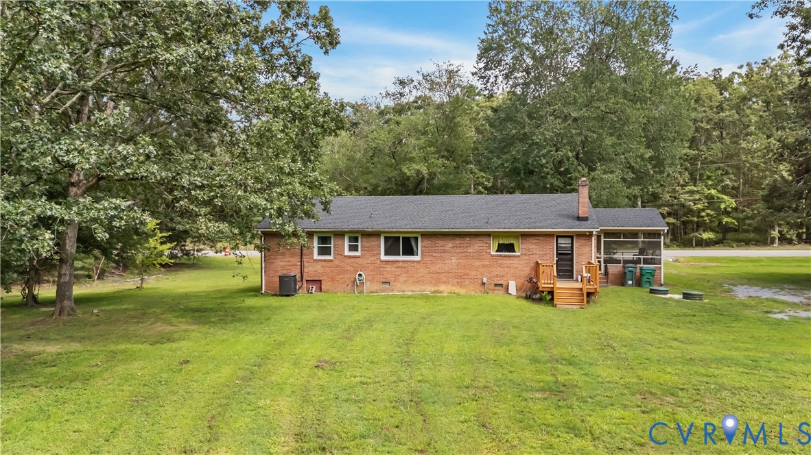 7586 Willson Road Henrico, VA 23231 - Photo 30 of 32 Rear view of house featuring crawl space, a lawn,