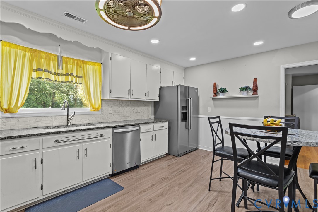 7586 Willson Road Henrico, VA 23231 - Photo 10 of 32 Kitchen with light wood-style flooring, white cabi