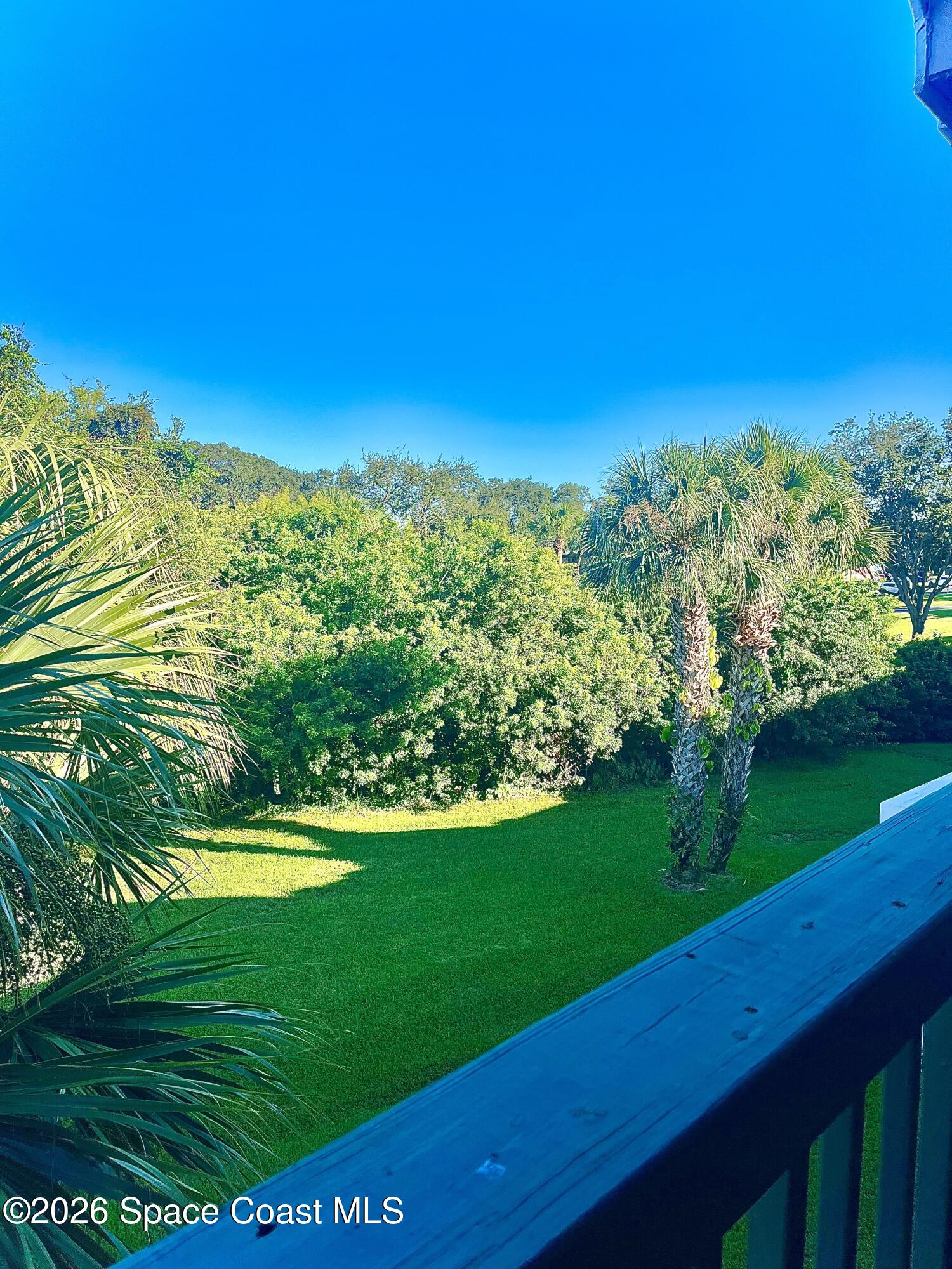 7667 North Wickham Road, Unit 1118 Melbourne, FL 32940 - Photo 9 of 26 a view of a green field with clear sky