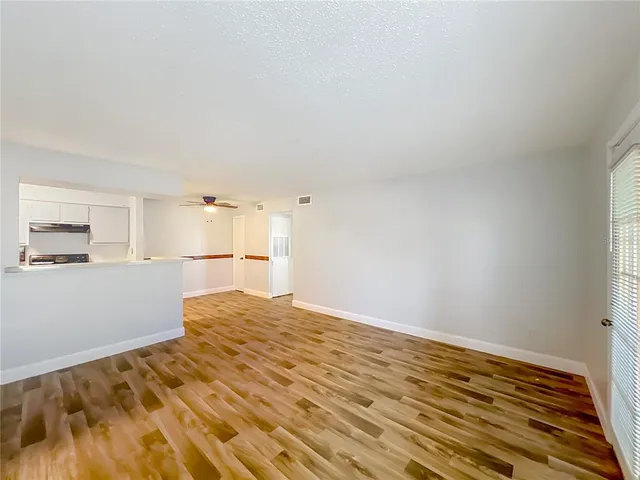 a view of a kitchen with wooden floor and a kitchen