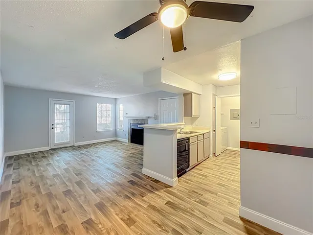 a view of empty room with wooden floor