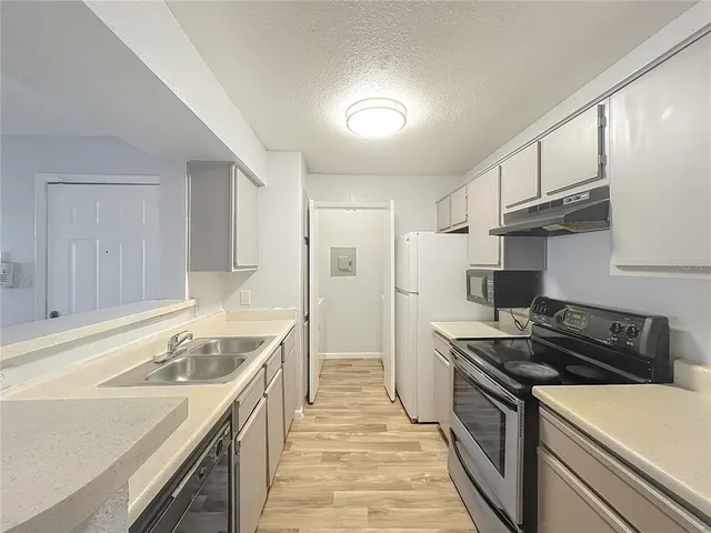 a kitchen with stainless steel appliances a stove a microwave and cabinets