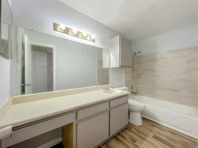 a bathroom with a sink a toilet and bathtub