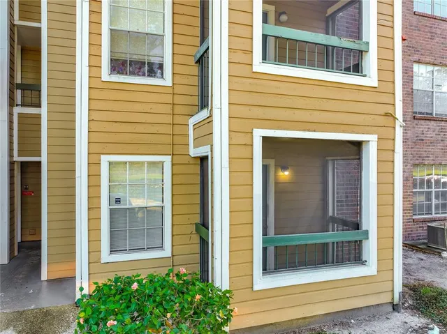 a view of a brick house with a large windows and a large window
