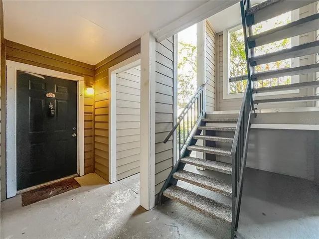 a view of entryway with stairs and wooden floor