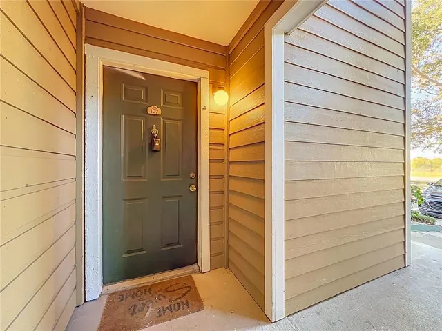 a view of empty room with wooden floor and fireplace