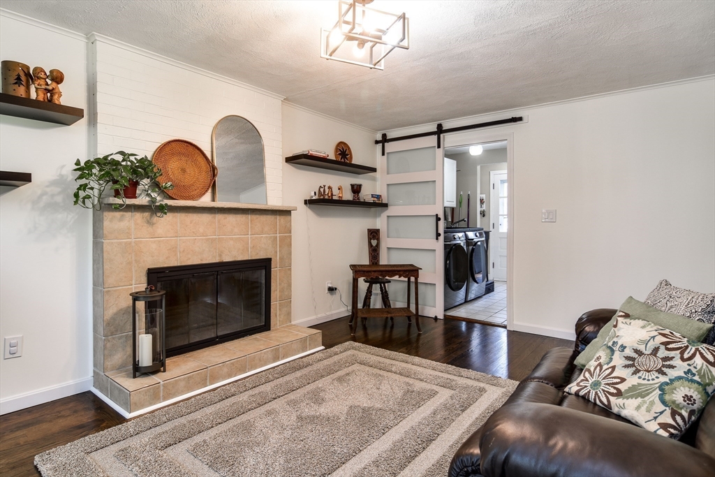 1 Woodside Road Framingham, MA 01701 - Photo 13 of 41 a living room with furniture and a fireplace