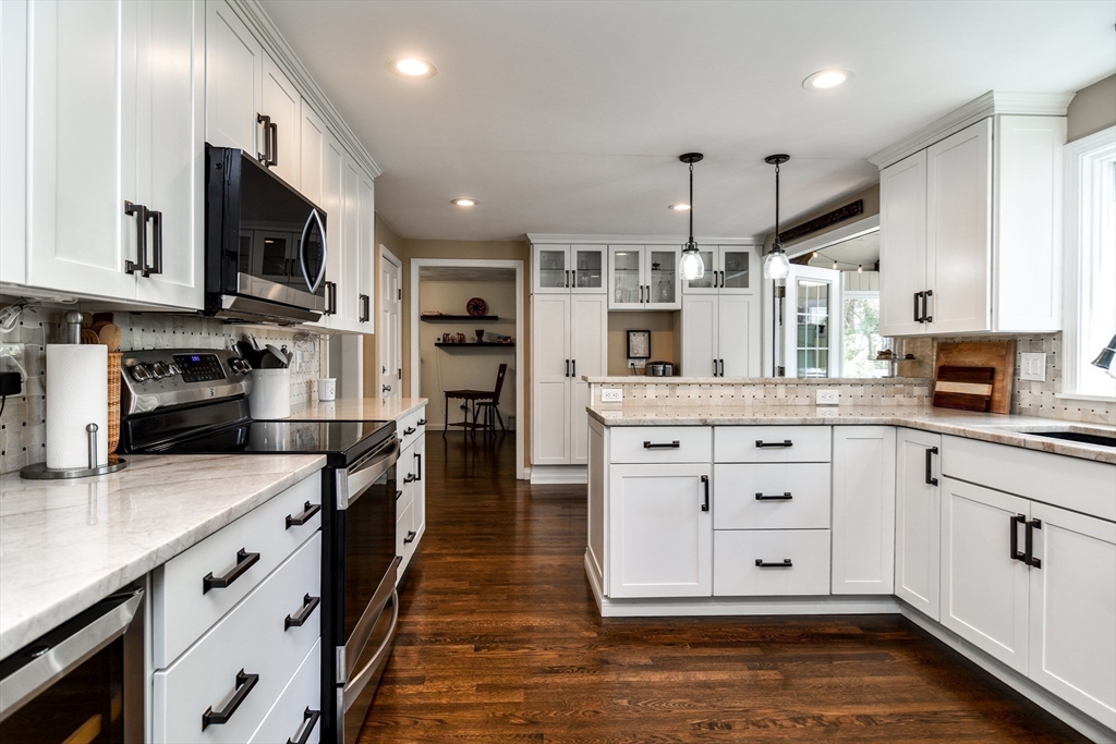 1 Woodside Road Framingham, MA 01701 - Photo 6 of 41 a large kitchen with stainless steel appliances kitchen island granite countertop a stove and a sink