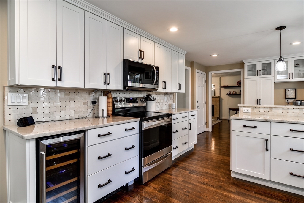 1 Woodside Road Framingham, MA 01701 - Photo 8 of 41 a kitchen with stainless steel appliances granite countertop a stove sink and cabinets