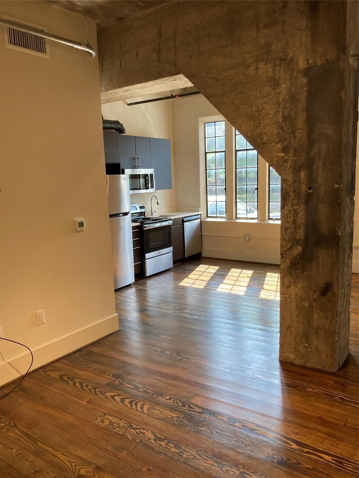 4411 Dallas Street, Unit 3 Houston, TX 77023 - Photo 2 of 12 a view of a kitchen with a stove and wooden floor