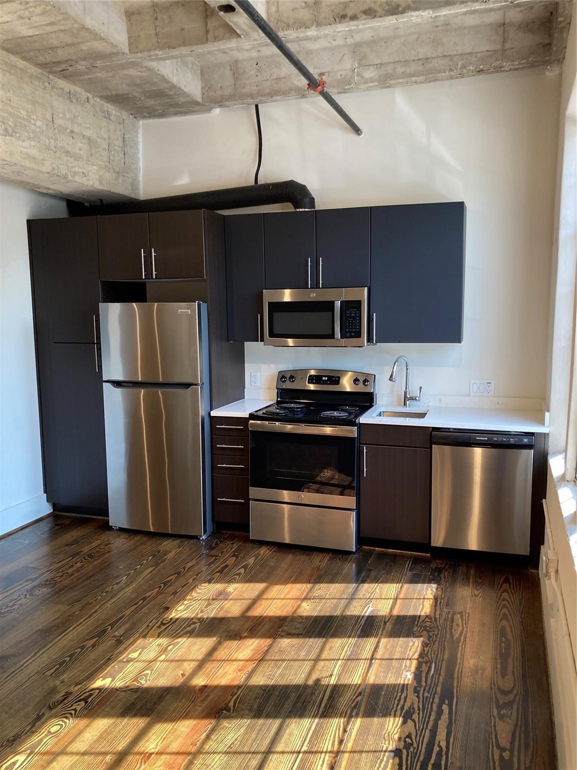 4411 Dallas Street, Unit 3 Houston, TX 77023 - Photo 3 of 12 a kitchen with stainless steel appliances granite countertop a refrigerator a stove and a sink