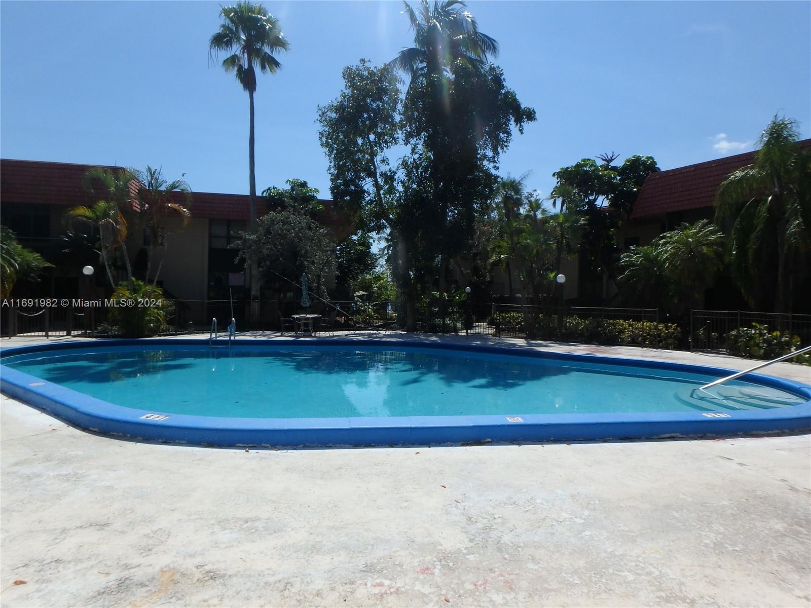 740 Northeast 199th Street, Unit 206G Miami, FL 33179 - Photo 14 of 14 a view of yard with palm trees