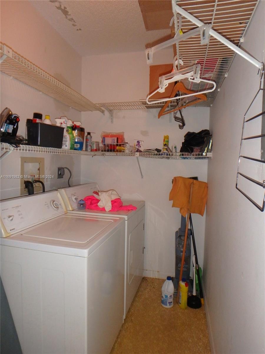 740 Northeast 199th Street, Unit 206G Miami, FL 33179 - Photo 8 of 14 a utility room with dryer and washer
