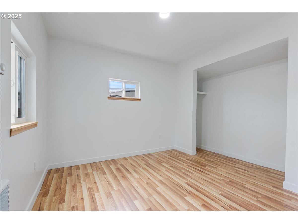 8951 Southeast Fuller Road, Unit 36 Happy Valley, OR 97086 - Photo 14 of 27 a view of an empty room with wooden floor